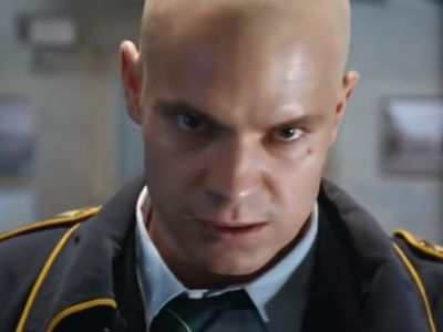 Timothy Olyphant is intensely staring at a screen.